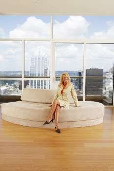 Portrait of a businesswoman sitting on a couch in an office