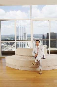 Portrait of a businessman sitting on a couch in an office