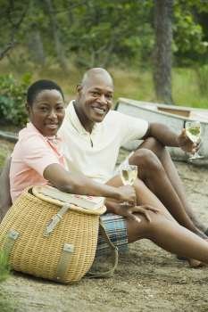 Portrait of a couple holding glasses of wine and smiling