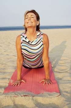 Mature woman exercising on the beach