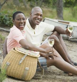 Portrait of a couple holding glasses of wine and smiling