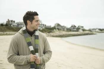 Mature man standing on the beach and smiling