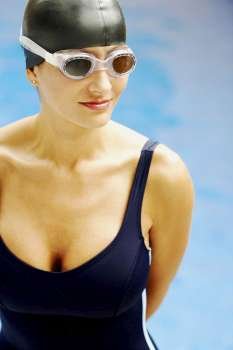 Mid adult woman standing near a swimming pool