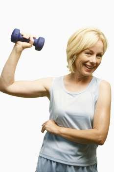 Portrait of a mature woman exercising with a dumbbell