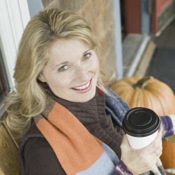 Portrait of a mature woman holding a cup and smiling
