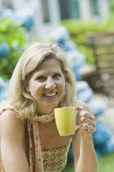 Portrait of a mature woman holding a tea cup and smiling