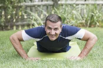 Portrait of a mature man practicing push-ups