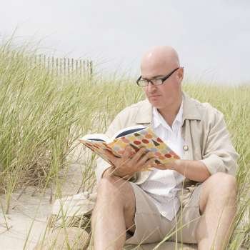 Mature man reading a book