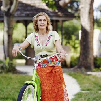 Mature woman standing with a bicycle