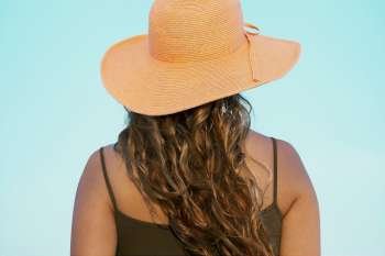 Rear view of a young woman wearing a hat