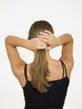 Rear view of a woman adjusting her hair