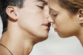 Close-up of a mid adult man and a young woman kissing
