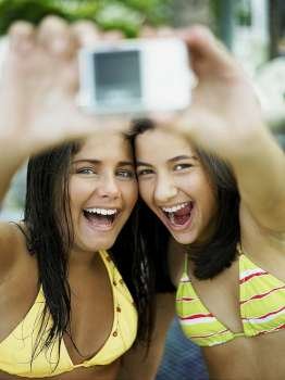Close-up of two teenage girls taking a picture of themselves