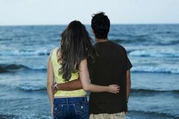 Rear view of a young couple standing on the beach