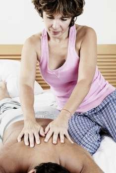 Mature woman massaging mature man´s back