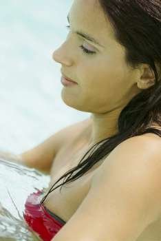 Side profile of a young woman in water