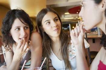 Close-up of three young women in a restaurant
