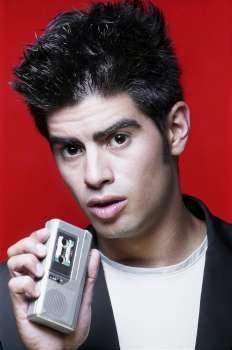 Portrait of a young man holding a Dictaphone