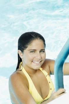 Portrait of a teenage girl smiling in a swimming pool
