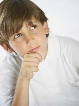 Close-up of a boy thinking with his hand on his chin