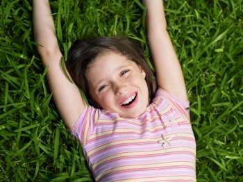 High angle view of a girl lying on the grass