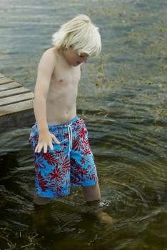 High angle view of a boy walking in water