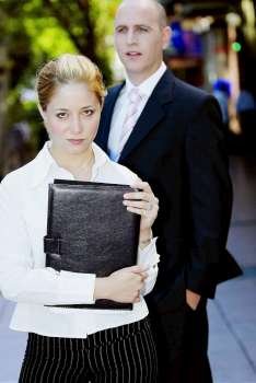 Portrait of a businesswoman standing with a businessman