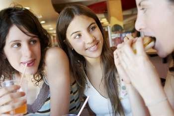 Close-up of three young women in a restaurant