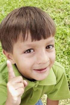 Close-up of a boy pointing and smiling