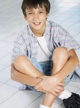Portrait of a boy sitting on the floor