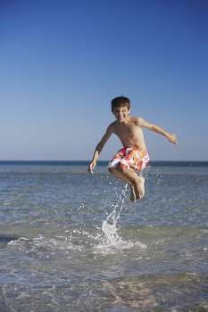 Boy jumping in the sea
