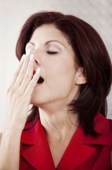 Close-up of a businesswoman yawning