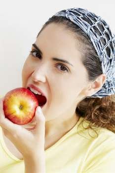 Portrait of a young woman eating an apple