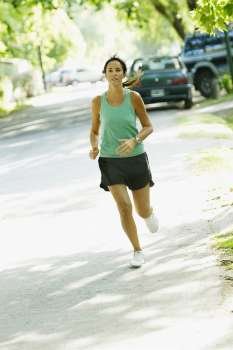 Mid adult woman jogging on the road