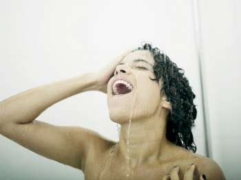 Close-up of a young woman having a shower