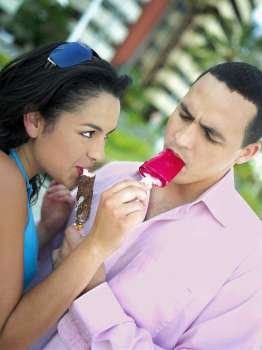 Close-up of a young couple eating ice cream