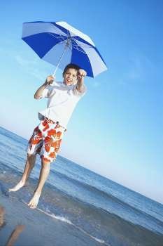 Boy jumping with an umbrella