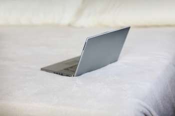 High angle view of a laptop on the bed