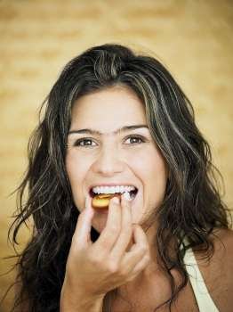Young woman eating a cookie
