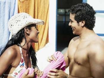 Close-up of a young couple holding a towel and smiling
