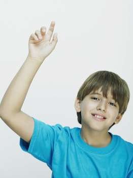 Portrait of a boy pointing upwards
