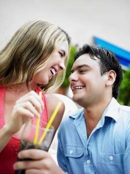 Close-up of a young couple holding glasses of cold drinks