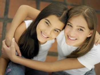 High angle view of a teenage girl hugging her sister