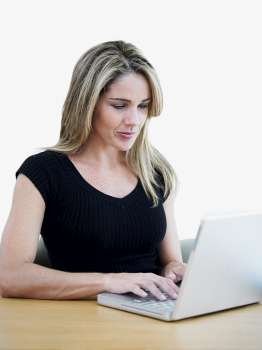 Mid adult woman using a laptop
