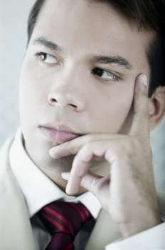 Close-up of a businessman thinking with his hand on his chin