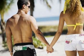 Rear view of a couple holding hands