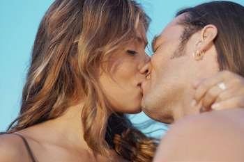 Close-up of a mid adult man and a young woman kissing each other