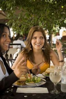 Close-up of a mature woman and a mid adult woman sitting in a restaurant, Santo Domingo, Dominican Republic