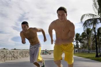 Two friends race each other at the beach