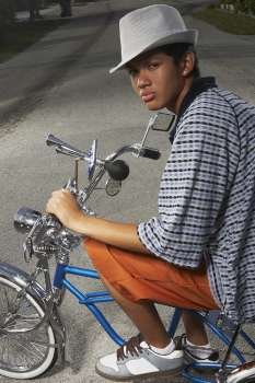 Portrait of a teenage boy cycling on a low rider bicycle